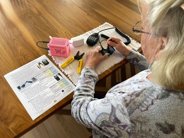 Grandmother following directions making a ham ASL node